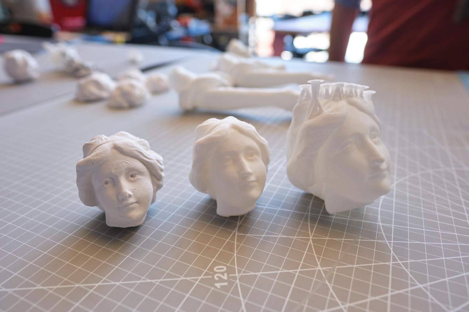3D printed plastic heads used to repair a historic plaster relief.